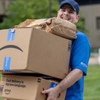 Volunteer carrying in stack of boxes